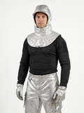 A man wearing Aluminized silver and black bodysuit costume with a hood, quilted collar, padded chest, matching gloves, and metallic pants, photographed against a plain light gray studio background.