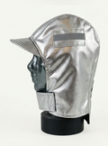 A metallic silver protective hood with a visor and chin strap, displayed on a black mannequin head against a plain light background.
